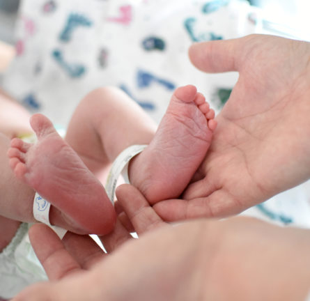 Hugs Tag System attached to baby's ankle